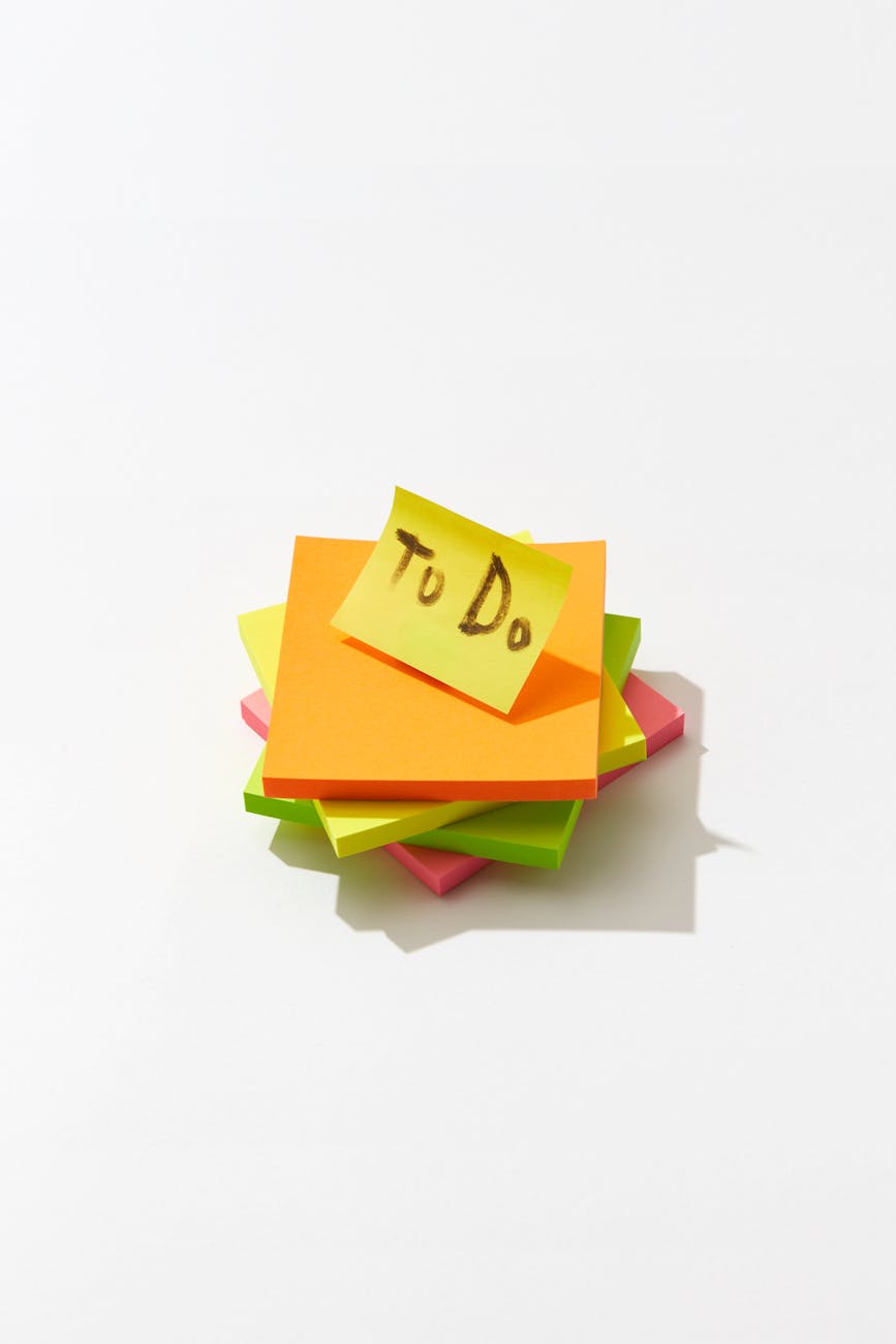 a to do note on a stack of sticky note pads